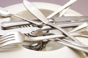 Recently polished and cleaned silverware displayed on a dish